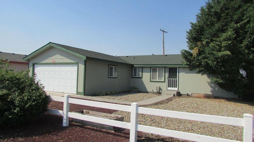 Beautiful 1998 Fuqua 1,144 sq. ft. double wide manufactured home built on a foundation with an attached approx. 400 sq. ft. two car garage and an additional approx. 440 sq. ft. covered screened patio on a concrete slab. Property is fully fenced and has very low maintenance landscaping.  This home is neat as a pin and ''turnkey'' with recent roof, exterior paint and Carrier Air/Heat Pump.  Master bedroom set will go with the sale if the buyer so desires.  Also, there are 3 storage cabinets in the garage and some shelving in the small bedroom that can stay with the home. The home feels like ''stick built'' and is on it's own lot, so no HOA fees or park fees.