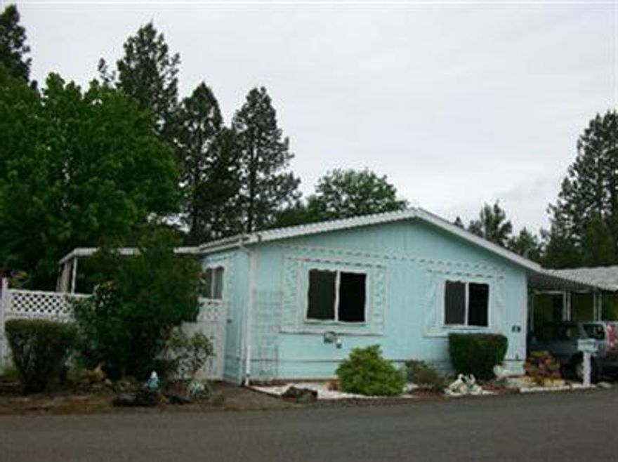 What a sweet deal on this updated 1991 home in Shady Cove 55+ park close to grocery & post office. Newer laminate floors in living rm., dining rm., hall, kit., utility & newer vinyl in 2 baths. There is also a wonderful near new pellet stove & nice cellular shades t/o. Open kit. has snack bar, lg. sideXside ref.& built-in desk. M/bdrm has walk-in closet & 60 shower in bath. You will love the yd. with covered deck, new vinyl front fence & new wood rear fence. There is also a 10X16 shop/shed with cabinets & shelves. Home warranty included. Possible owner carry with good down.