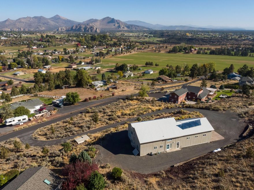 Unlimited possibilities await you at this property! Built as a pole barn w/living quarters the home was designed to take full advantage of the views while incorporating a garage mahal! The main floor features the kitchen w/propane range w/hood, microwave, dishwasher, refrigerator & large pantry. The window over the kitchen sink is perfectly placed to take in Smith Rock! The large great room takes in all the views including Jefferson & is plumbed for a propane fireplace. Laundry room w/shower, toilet, 2 sinks, washer/dryer, solar tube and folding area. Upstairs is a large loft area (2nd bedroom) w/2 oversized storage rooms & full bath. So much potential to expand for your own needs. 10 zone In-floor radiant heating system, water coil system heated w/solar & propane on the main floor and garage--all zones are adjustable. Heated garage features 3 bays, 2-14 foot doors & 1-10 foot door. Garden areas w/water and power. Driveway surrounds the home for easy access and fire protection