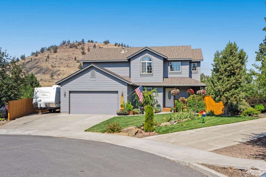 Beautiful 2-story Midtown home on a quiet cul-de-sac! The open floor plan boasts laminate wood flooring, gas fireplace in the greatroom, A/C, and lots of natural light! Spacious kitchen features granite countertops, undercabinet lighting, SS appliances, double oven, breakfast bar, and built-in desk. The master suite includes an extra large walk-in closet, tile shower and soaker tub in the master bath, and a private balcony to enjoy the stunning Cascade Mountain views AND a front row seat to 4th of July fireworks on Pilot Butte. Good sized guest rooms - one of them has 2 closets! Over-sized 2c garage has built-in shelving for storage and a workbench. The backyard is fenced and landscaped with a garden area, chicken coop, covered deck with a hot tub, storage shed, and plenty of room for your RV and toys! Great location close to schools, shopping, medical facilities, and easy access to downtown Bend.