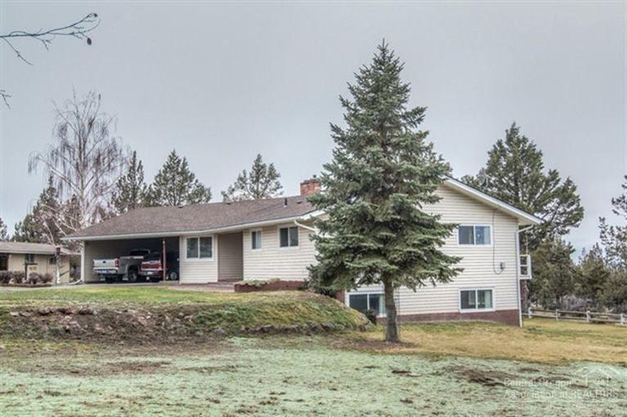 Great 3,172 square feet, 4 bedroom, 3 bath home located on 5 acres with views of Powell Butte and Smith Rock. With a daylight basement having additional bedrooms and a family room, all the main living areas are on the entry level including the master bedroom. Other features include: stone fireplace; electric heat pump; pellet stove; glass enclosure on the deck off the dining room; front patio with pavers; newer roof; 2 bay attached carport; enclosed 3 sided shop with concrete floor.