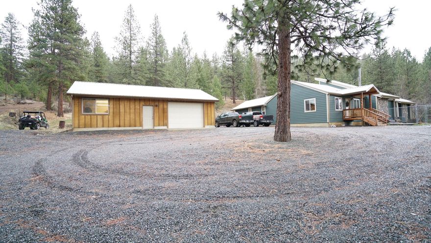 Beautiful home setting in the pine trees Bordering BLM (Public Land). This home was built in 1977 and remodeled extensively in 2017. Home offers nice open floor plan with large expansive rooms.  Two primary bedrooms with bathrooms. 4 bedrooms in total w/4th bedroom being used as a nice office. 3 bathrooms total in the home. Gorgeous granite countertops in kitchen, vaulted ceilings, large dining area and gathering area with a Blazeking woodstove. Large walk in closet for all your coats and boots/shoes. Expansive living room.  Large 26x40 finished shop with one electric garage door, 220 electricity, oil stove for heat and workshop area. Fenced yard with beautiful landscaping, retaining walls, covered patio. Perimeter of property has post set with fencing strung but not installed. New hotwater heater & septic tank installed in 2021. This is a beautiful property with access to miles and miles of public land. Very private setting at the end of the road.