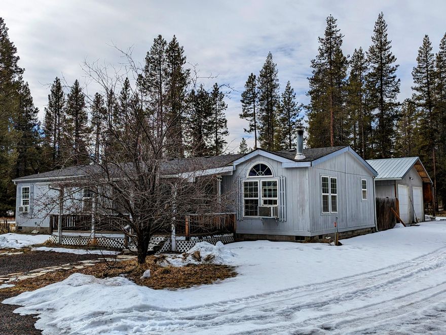 Welcome to 52911 Day Rd. 1.11 quiet and private acres on a corner lot. Great open floorplan with a living room and a family room. Vaulted ceilings,with skylights provide an abundance of natural light. Kitchen has lots of storage. Family room with certified wood burning stove. Master suite has a walk-in closet and bath has a soaking tub.  Laundry room has a utility sink and access to the back courtyard. Detached oversized garage with 2 doors. Garage has two rooms - what will you do? Driveway on both Day Rd and Cedar - makes it easy to bring in and drive out with all your Central Oregon toys. Home is set back from the paved road making this a slice of paradise! Minutes to La Pine schools and shopping. Come and enjoy all that this property offers.
