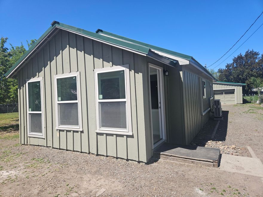 This beautifully renovated 2 bedroom, 1 bathroom home offers 1093 sq. ft. of living space. The home features a brand new metal roof, as well as updated flooring, updated kitchen with new range and dishwasher. Updated bathroom with new vanity, toilet and light fixture. Interior and exterior have been repainted. New vinyl windows, light fixtures, interior and exterior doors. Nice laundry room with new water heater. There is a bonus room that would make a great office. The layout allows for easy flow between the living room, dining area, and kitchen. Large 1 car garage has 900 sq. ft.