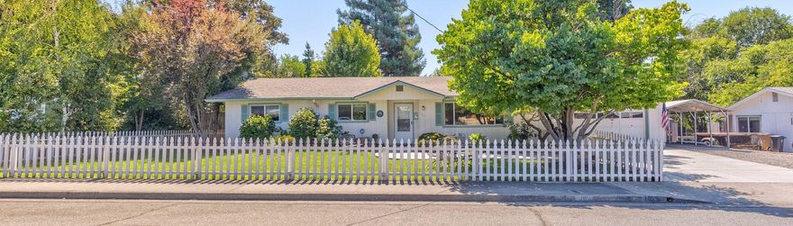 The American Dream, complete with a redwood tree and white picket fence. On a quiet cul de sac, neat, clean, and move in ready. Single 3 bed, 2 bath, 1290' main house with fireplace, screened in porch, attached ADU/apartment/in law quarters, 300', with bath, 2 car attached garage and carport, large shed could be shop, 2nd ADU or storage. All on over .25 acres in town. This is the one!!