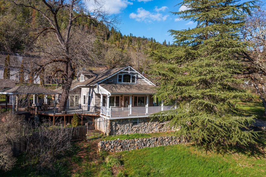 Historic Oregon Retreat in Serene Southern Oregon. Bybee Springs Ranch, est. 1892, was a destination resort beautifully restored on 153.59 sub- dividable acres next to BLM. Only 20 minutes to Rogue River, this 2,160sqft. 3bdrm 2.5bthrm, home greets you with an expansive, covered, wrap around deck.  Details abound-Elegant living-room has 11ft ceilings, gas fireplace insert, wood trimmed Pella windows. Open beam ceiling in dining/kitchen w/ Vermont Castings Woodstove. Enjoy hot tub & Wysteria covered pergola over-looking garden area/2 outbuildings. Primary bed/bath, walk-in closet on main floor. 2 large bedrooms & guest bth upstairs.  4 car 2 bay garage/shop, 2 studios above.  5th wheel w/RV hook ups.  Inground pool w/water feature. 2 wells. 1 mile Evans creek frontage, School House blt 1913, updated 2012. 14 acres of Irrig. rights, 5 meadows, lovely trees, trails, gardening areas with sun, swimming holes, fishing, gold panning & picnic areas await. Gorgeous family compound opportunity