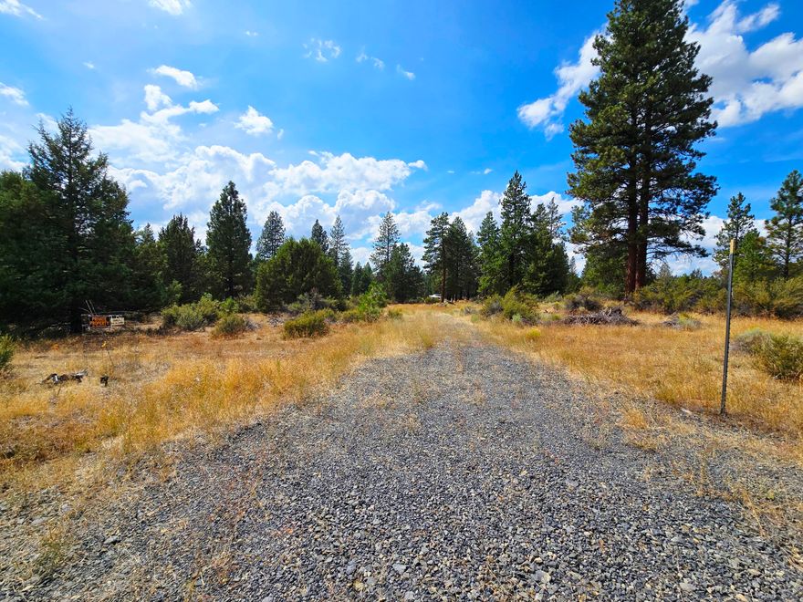 Discover 4.60 acres of level Oregon land with natural beauty and practical features. A capped well and septic system are already in place, along with a gravel driveway for easy access. The property is dotted with mature trees, offering privacy and a serene setting. Located on a quiet dirt road, yet just one lot from the paved road where power is available, this parcel combines a peaceful retreat with convenient access. Buyers are encouraged to verify all zoning, building, and utility details with the county.
