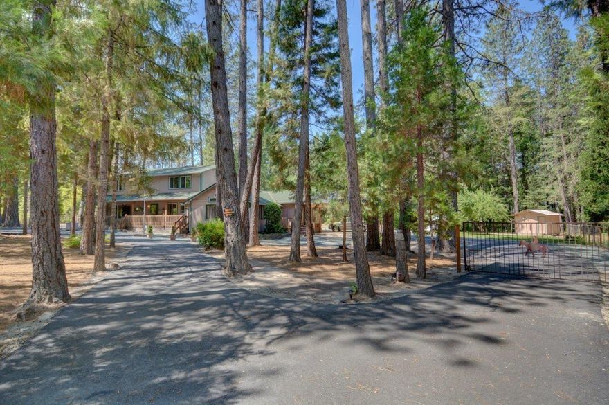 NEW PRICE! $469,000 Welcoming and peaceful 2 story country home with full master suite on main floor, 1.77 acres of low maintenance scenery, gated and completely fenced. This 3064 sf home has it all! Several large entertaining areas with a kitchen that serves all the rooms and the wrap around deck easily. It has 3 master suites (1 down/2 upstairs) each with their own bath and walk in closet. Plus half bath downstairs. The home features a natural rock fireplace, skylights, large picture windows and a whole lot of peace and quiet outback...speaking of out back, there is a 30 x 40 shop with 220 and multiple car ports nearby, and a separate 1 car garage, with RV hook-up too! With the downstairs master leading out to the deck, it very easily could suit a 2 family situation. Come take a look today!