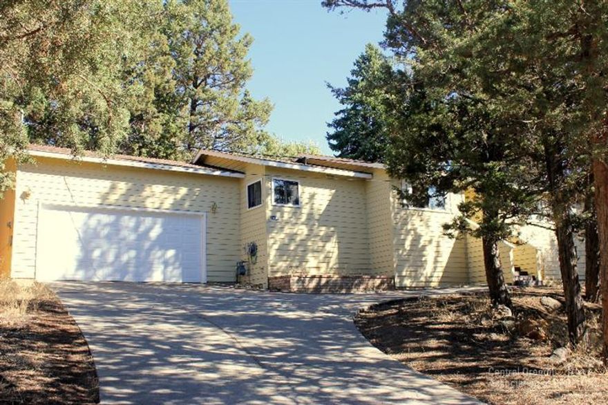 Great Westside home! Walking distance to many amenities. This home sits on a very large .29 acre lot with a ton of potential. Zero-scaped for easy maintenance right now. This home has new carpet, tile kitchen counters, a double car garage and nice screened in porch with gas stub for easy BBQ-ing. Open, great room concept with a gas fireplace and nice big windows to let in the Southern Exposure light. 2 Bedrooms and 2 baths, one with en-suite make this home very comfortable and spacious feeling.