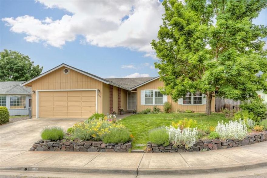 Don't miss this move-in ready in a quiet, family-friendly Talent neighborhood. This 3 BD/2BA home features vaulted ceiling, hardwood bamboo flooring in the living room/dining area, a separate dining nook, a covered patio off the kitchen for relaxed outdoor dining. Separate laundry room off kitchen includes wall cabinets for extra storage. Master bedroom features a coffered ceiling and walk-in closet. Artistic touches abound with custom tile in the bathrooms and kitchen, designer lighting. New double-pane vinyl windows and Craftsman trim in 2011. Automatic sprinklers front and back yard. Spacious fenced back yard features a privacy hedge, apple trees, flowers, strawberries, raspberries, storage shed. Mature Maple trees provide summer shade. This super-quiet home in a well-kept neighborhood just blocks from downtown Talent is a rare find!