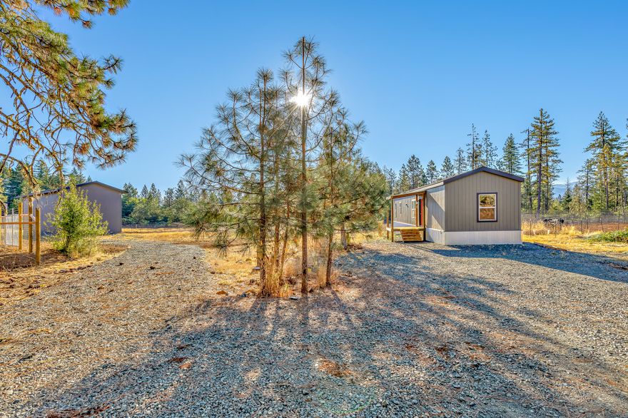 Turnkey growing/farm opportunity! Enjoy 10 acres of farmland that has been meticulously cleared, fenced, and wired with a Vianet surveillance system to meet OLCC standards. The 300'+ well boasts a consistent 6GPM. The 1,500' commercial shop has multiple levels, a bay door, and is wired for 200-amp power. The 2017 manufactured home is also wired for 200-amp power, with surveillance throughout. Inside the main home, you will find a practical layout that maximizes space between its 2 bedrooms and 2 bathrooms. In addition to the modern interior/amenities, the property also has cell service, a great convenience for a rural farm property. Off your back porch, the Rough & Ready swimming hole is a short 3-minute walk away. You are adjacent to 290,000 acres of Siskiyou National Forest, and have the year-round Parker Creek running through your property. Property can be subdivided, and has an active Tier 2 license in place as well.