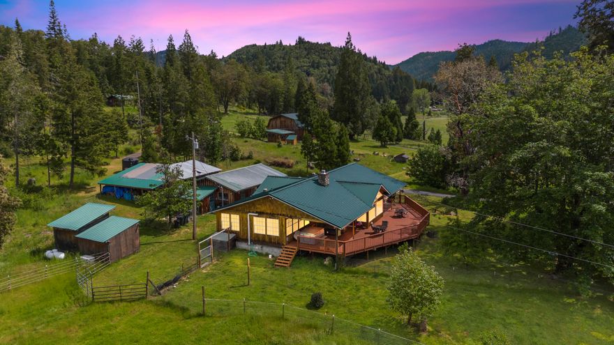 Best Equestrian Property in Southern Oregon:  68x144' Covered arena w/ 11 stalls & turnouts, wash rack with hot water, and multiple pastures to ensure your horses have room to roam. Hay storage, insulated tack room with living quarters above arena or use for announcer's booth.  Multiple out buildings for equipment storage & shop. Feeder barn and additional barn with 3 stalls, tack room, turnouts and pasture. Your own hay field & 50 acres of irrigation rights. 2 RV full hookups. This home offers open living space.  Kitchen includes double ovens, island with pot filler, farm sink, ample storage, granite counters and a breakfast bar. There is a deck/covered living space off front of home to enjoy the sunrises and sunsets.  Primary suite has large walk-in closet, dual vanity and shower.  2 more nicely sized  bedrooms on other side of living space and guest bath. Main house has a Generac and SOLAR! Self efficiency abounds here.   Additional Homesite/Address is at property as well