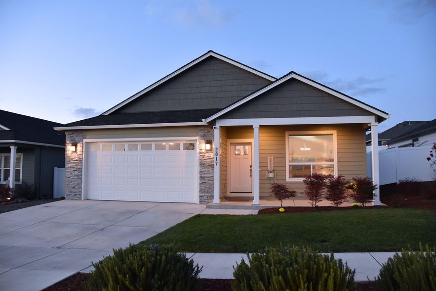 Gorgeous East Medford Home!  Open Floor plan with Vaulted ceiling & tiled floors(Warm wood grain style). Craftsman style doors, Neutral Taupe color walls w/White trim/casings throughout home= CLEAN!  Large front living room that looks onto the Kitchen w/ quality Cabinetry/hardware, Granite counter tops, Stainless Steel Appliances, gas range, counter eating area, drop & recessed lighting. Spacious Dining room area w/transom window and slider out to the covered patio and beautifully landscaped yard. Primary Bedroom/suite offers breathtaking bathroom w/ 2 separate vanities/Granite counters upgraded sinks & fixtures, Large walk-in tiled shower/glass doors/bench, also a walk-in closet. Hall Bathroom offers some of the same upgraded materials as primary. The 2nd bedroom is oversized. 3rd bedroom is standard size. Also, Laundry room that gives access into the 2 car garage. Located close to all shopping.