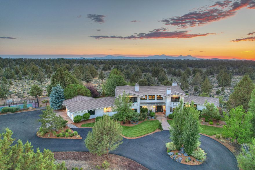 Don't miss this opportunity to own one of the most spectacular properties in Central Oregon! Surrounded by public land on 3 sides, this well-landscaped estate has been extensively updated with high-end designer finishes all throughout! The home features a master on the main floor boasting huge Cascade Mountain views and also has 4 additional en-suite rooms upstairs, all with private decks,  in addition to a large bonus room and private office/study. There is also an integrated entertainment system, 2 laundry rooms, huge 4,300 sq/ft shop with a mancave, sport court, historic barn/apartment, and an incredible entertainment/recreation area with pond, beach, gazebo, fire pit all surrounded by a huge lawn. The 10 acres of water rights for the pasture are served from the property's private well allowing for worry free watering. 5 acres of manicured pasture are perfect for horses or a small farm. This is one of the most secluded and private acreage properties in Central Oregon.