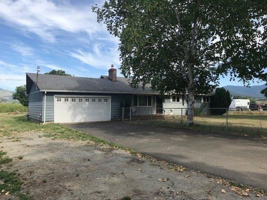 This pleasant country charmer has TID irrigation that can be used for those 4 H projects, or you can just green up the surrounding grounds and entertain family and friends. Large conifer shade trees line about half the property, and the other half is flat and open with lots of sun exposure. There are some small outbuildings and property is mostly fenced. Big 2 car attached garage. This home offers any family opportunity for living on small acreage. The home is a one level layout and partially floored with hardwood. Master bath has been updated. From the cabinet studded kitchen an addition was added which can be used multi-purposely as family/Rec or dining room. To bring this home to its glory days you need to bring a little love. Country settings on small acreage like this doesn't last long.