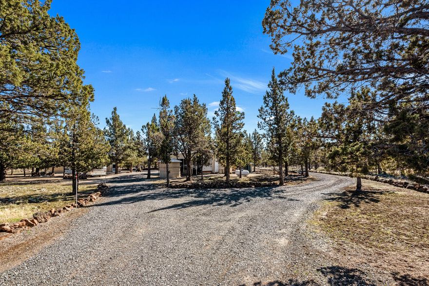 Nestled off the main road you will find a peaceful property on a cul-de-sac in this private gated off grid community. This property is ready for camping or building your custom home.  A second story home would capture the views of 3 Sisters and Mt. Jefferson. A 40x48 shop, concrete floor, and two 12' roll up doors for storage of all your toys. A covered metal shelter protects the 40' Jayco Trailer with 2 slide outs, A/C, W/D combo and a full size refrigerator. Upgraded solar in 2021. Outside the trailer is a tranquil covered patio to enjoy the shade after a long day on the lake.  An additional dump station and an additional 1992 30' travel trailer is included.  Septic tank replaced in 2019, 1350 gallon water cistern.  Three Rivers Recreation area has a marina, boat launch on the Metolius Arm of Lake Billy Chinook, private beach, Airstrip, Gun Range, Desert Golf, trails and many outdoor activites for everyone. 
 Come enjoy all the amenities this property and community has to offer.