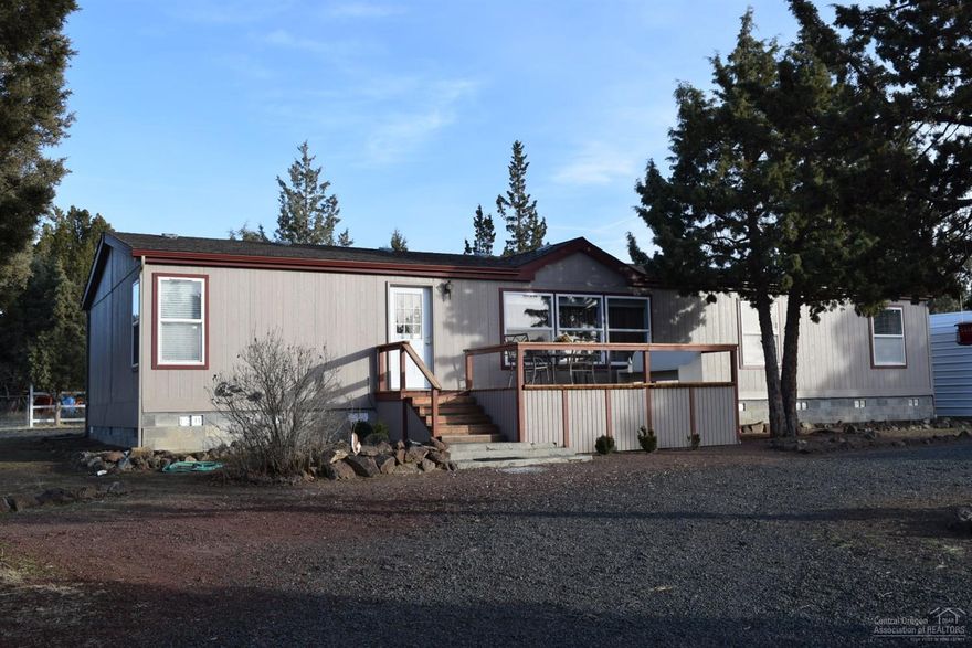 Relax and enjoy a peek a boo Mountain view from this fenced and gated 1.83 acres featuring a spacious 3 bed, 2 bath, 1782 sq ft, light and bright manufactured home, island kitchen, split bedrooms, expansive windows, exterior paint using brush and roll technique, newer heat pump, decks and more. Top it off with a truck shelter, small shop, greenhouse, plus storage buildings and you have Country Living at it's best. Close to BLM. Just 13.7 miles to new Prineville Hospital. Sq footages and mileage estimated.