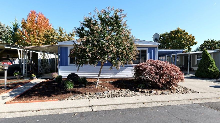 Modern luxury at an affordable price. Extensively remodeled 2-bdrm, 2-bath home w/over 1,200-sq. ft.  is located in the 55+ community at Aspens on the Creek. You will not find a more luxurious, upgraded, tastefully remolded home around.  The spacious open floor plan provides a comfortable feel while allowing tons of natural light throughout.  All upgrades have been done in the past year. Exterior boasts a wonderful covered patio, new outside paint, nice sized carport, 2-sizeable sheds & newly done low maintenance landscaping. Inside boasts an all-new kitchen w/custom soft close cabinets, Quartz countertops, LG Think Q Stainless appliances, farm house sink & more.  Both bathrooms have been redone & the primary suite has a spacious walk-in closet w/built ins. You won't believe the attention to detail w/custom features throughout including luxury carpet w/memory foam padding, custom ceilings, fixtures, high end LVP flooring & more. Space rent is super affordable @ only $675/mo.