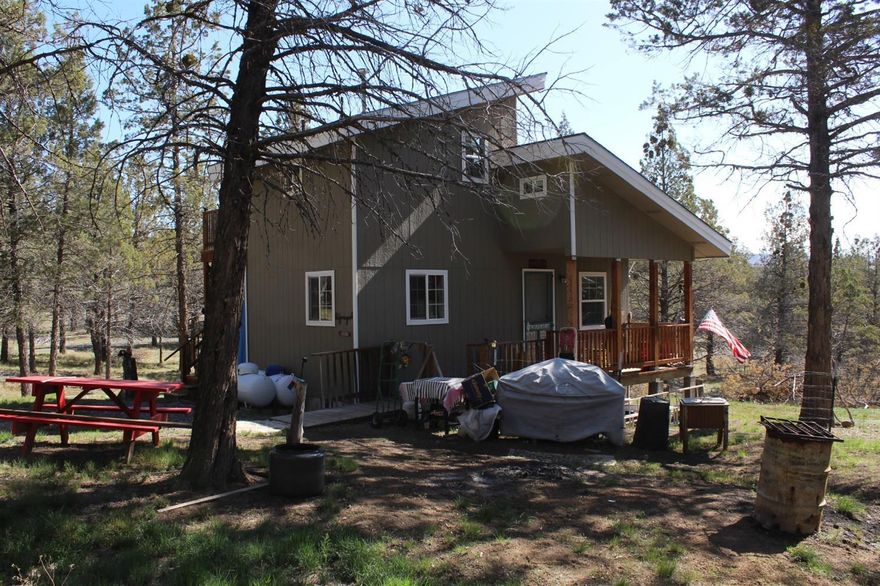 Cute and cozy off-grid cabin nestled amongst the trees on 28+ acres in Malin. Home has beautiful views of the surrounding area off of the upstairs deck. Kitchen was updated with new cabinets and counters. Fresh paint inside and out. It has a new solar system with generator backup. Propane refrigerator and propane stove/oven stay. There are also washer/dryer hookups available. Home has a wood stove that keeps it warm in the winter and also has propane radiant heat for backup. The main bedroom is downstairs, and the second bedroom/craft room is upstairs with a deck off of it and stairs leading down to the ground. The storage shed is negotiable.