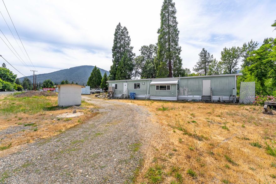 Endless Possibilities at an Incredible Value! 
This unique property is zoned Rural Commercial and offers a wide range of potential uses—conveniently located in Selma, Oregon, just 20 miles from Grants Pass and under 10 miles to Cave Junction.
The property includes a 1972 manufactured with 2 bedrooms, 2 bathrooms, and 792 sq ft, featuring a durable membrane roof. Also included is the original 1920-built home, offering 1,072 sq ft—currently used for storage, but ready to be restored with some TLC.
Enjoy the peaceful setting with a seasonal creek. Owner carry option available—don't miss this rare opportunity! 
Buyer to perform their own due diligence regarding all aspects of the property, including but not limited to zoning, permitted uses, condition, and suitability for buyer's intended use.