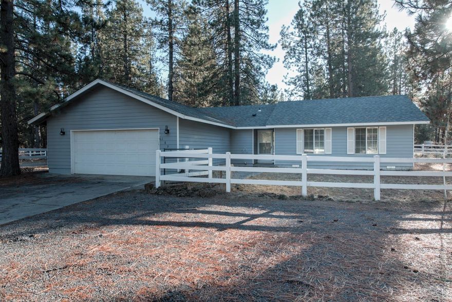 This beautiful property is ready for you! Bring your horses, your 4H animals or just use the fully fenced lot for your own special hobby! The gorgeous barn was built with custom stall fronts, paddocks that are built from Noble panels, and include automatic Ritchie waterers. The barn has a tack room, stained siding, and mats. Vinyl fencing and cross fencing, and a large, designated outdoor riding arena approximately 140 x 60 in size. Extra barn for hay storage, w/ add'l shed and lean-to for personal property. The home has an open floor plan with propane fireplace with remote, new carpet, new vinyl flooring in bathrooms and new roof in 2017. Trailering of horses to ride is not necessary from this location. You can ride your horses a short 30 minutes to reach BLM land off Osage Rd. The BLM trail goes through the trees along a lava flow, and is beautiful.