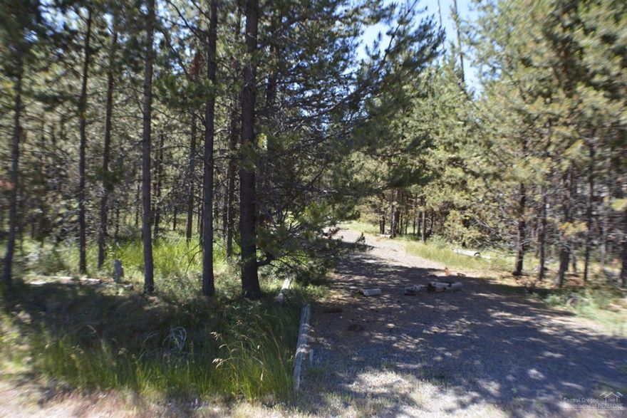 Level treed lot close to the Big Deschutes River, Cascade Mountain Lakes, & Mt. Bachelor. Just 20 minutes to Bend. Located on a paved road.