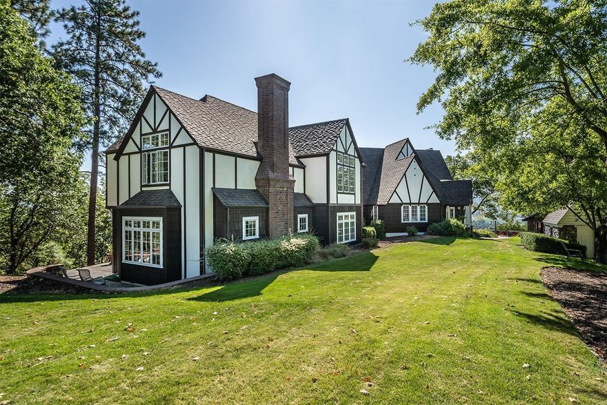 Amazing 7-acre estate property w/magnificent valley views & a large, wonderful Tudor style home. Located just outside Historic Jacksonville this gated & private 5 bed, 4.5 bath home beautifully blends indoor & outdoor living making it perfect for entertaining. Vintage charm & finely finished architectural details are seen on each level w/boxed beams, hardwood floors, 2 spiral staircases, soaring ceilings & picturesque Tudor arches. Stunning master suite w/a fireplace, wet bar, sitting room, 2 walk-in closets & 2 separate sleeping areas w/convenient elevator access. Luxurious ensuite w/heated travertine floors, double headed shower, dual sink vanity & soaking tub. Expansive family room w/a soapstone Tulikivi heater, wall of windows & separate game area. Light & bright kitchen w/slate floors, painted white cabinetry, pantry & eating bar w/deck access. Charming stone pool house w/a half bath, large inground pool, lighted sport court, oversized 2 car garage, carport & asphalt driveway.