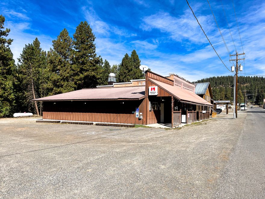 Motivated Seller! An opportunity to own a bar and restaurant in historic Sumpter, Oregon, is available. This charming town, rich in Old West history, offers a variety of outdoor activities. The property features a prime location with ample parking and a 3,492-square-foot commercial building previously used as a bar and restaurant. It boasts a fully equipped kitchen with a Wolf propane stove & ovens, charbroiler, deep fryer, a fire suppression system, and walk-in coolers and freezers. The bar area includes 10 stools, 9 tables, shuffleboard, and Video Lottery wiring, while the restaurant area offers 6 tables for 22 guests, with potential for expansion. Both the bar and restaurant have two half baths, and there's a covered patio for outdoor dining. Additionally, the property spans 0.56 acres and includes an extra 0.30-acre residential lot. The owner is willing to carry the contract for qualified buyers. Don't miss this exceptional opportunity!