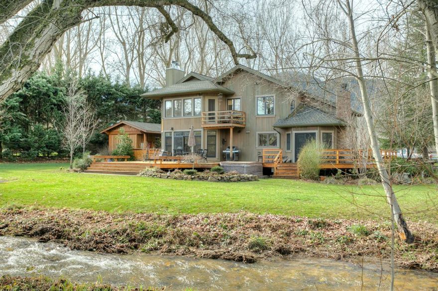 Single handedly one of the most gorgeous creek front settings in Ashland. Extensively remodeled in '08, the home sits off the road and is really private. Gorgeous country kitchen w/ honed granite countertops & farm sink. Spacious and charming dining area w/ fireplace. Light filled living room w/ fireplace and direct deck access. Knotty Alder doors & Marvin wood windows throughout. Upstairs master suite has a private balcony overlooking the creek, an incredible walk-in closet & spa-like bathroom with extensive tile & radiant floor heat. There is also an adjacent office space, full bath, + another bedroom with huge closet/bonus area. Main floor features 2 addtn'l bedrooms, 1.5 baths. Incredible ground & numerous, versatile outbuildings. Expansive deck, fire pit, pond and lots of room for gardens & animals. One stall barn, hen house, detached 120 SF office/man cave with electricity. 10 total acres. 7.5 are pasture with irrigation rights through the Taylor Ditch. Pond and more!