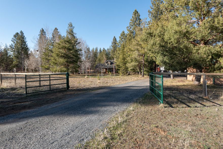 Situated in SW Bend on 2.5 very private gated and fenced acres, this large wooded property features an adorable 3 bedroom, 2.5 bath farmhouse style home, a large shop that could accommodate several vehicles including a Sprinter van and workshop, two additional sheds, and a large chicken coup. Situated outside of the Bend City limits, this property could qualify as a short term rental property, or would be perfect for raising animals. In 2017, the home underwent a complete energy savings upgrade performed by Neil Kelly. Upgrades included complete reinsulation, new heat pump, hot water heater, and air filtration system. Additionally in 2017 new tile floors were installed throughout the main level and new kitchen appliances were added. Newer features include fresh interior paint and carpet, grasses, and apple trees. Enjoy space, nature, and storage for all of your toys while just being minutes from the Old Mill with the ability to access all of the conveniences of being in town.