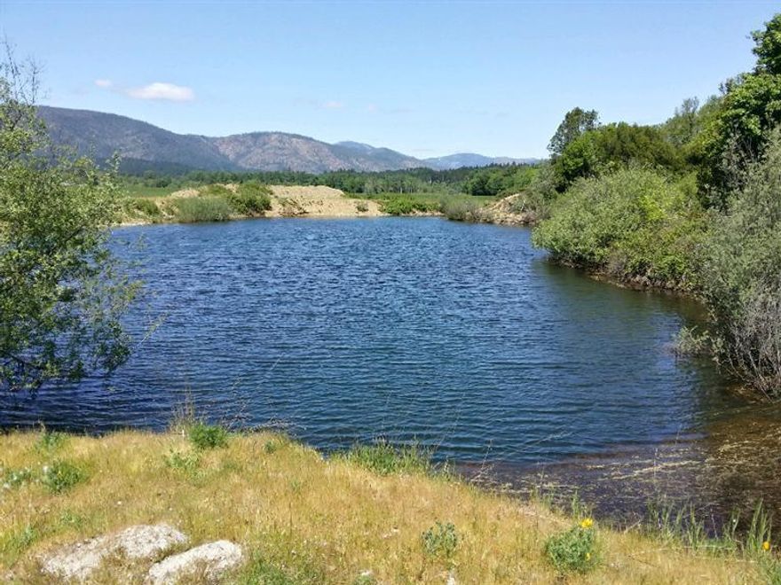 394 acres of some of the finest Ag land the Illinois Valley has to offer! This one of a kind property has over a mile of Illinois River frontage and 3 ponds. 4 br home built 1954, multiple outbuildings centrally located on estate. Underground irrigation, 2 large pumps and wheel lines included and used to farm over 200 ac grass & alfalfa. 285 +/- irrigated acres w/47 ac supplemental water rights dating back to the 1900's. 7 tax lots 100,300,403,404,1000,1003 & 1200 included in sale. Add'l home site approval. End of the road privacy to construct your dream home, vineyard, horse or cattle ranch! All information deemed reliable, but not guaranteed. All information should be independently verified.