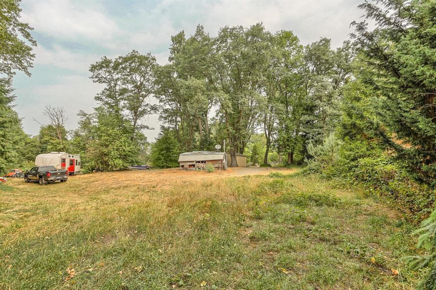 Beautiful creek side location for your new home! This private parcel is beautiful, 1.63 level acres surrounded by a canopy of mature trees in an area of upscale rural homes and horse properties. The property is gated and you will love the sounds of Neil Creek which borders this lovely setting. Perfect spot for your dream home with lots of room for gardening, animals or just relaxing in nature. All of this just a few minutes to downtown Ashland, fine dining and theatre.