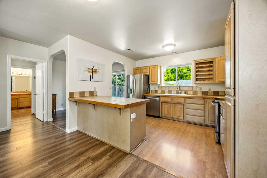 Tucked away on a private flag lot across from Bellview School, this well-cared-for home offers rare peace and quiet while staying close to hiking trails, shopping, and restaurants. Set back from the main drive, it features a split, open floor plan that feels spacious and inviting. Thoughtful upgrades include all-new stainless steel appliances, new landscaping with drip irrigation, and exterior paint in 2021. Interior paint and flooring were refreshed in 2018, and a new roof was added in 2016. The generous kitchen flows into an open living area, while the main bedroom offers a cozy 4x6 bay window seat and en-suite with dual vanities and marble-surround tub/shower. Sitting on a flat lot with mature trees, this home is in great condition and blends comfort, privacy, and convenience.