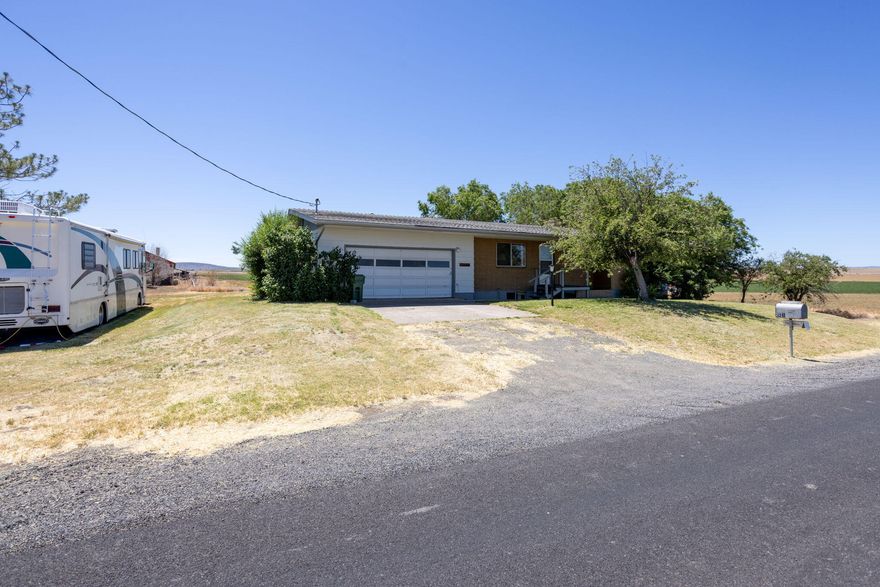 Plenty of room on this 5 bedroom property in the country surrounded by farm land and close to Lake Billy Chinook. Great primary residence or vacation home for the Central Oregon outdoor enthusiast. Inside, the kitchen featuring wooden cabinetry, offering plentiful storage. Natural light filters through the window above the sink, offering a view outdoors. The basement features an expansive recreational room. Here, a classic brick fireplace anchors the room, promising warmth and a focal point for gatherings during cooler seasons. The inclusion of a pool table showcases the room's versatility and scale. This space, complete with built-in storage solutions makes for a superb entertainment hub or potential in-law suite. This property, with its substantial living areas and the promise of outdoor transformation, is an offering poised for the next owner to make it their own.