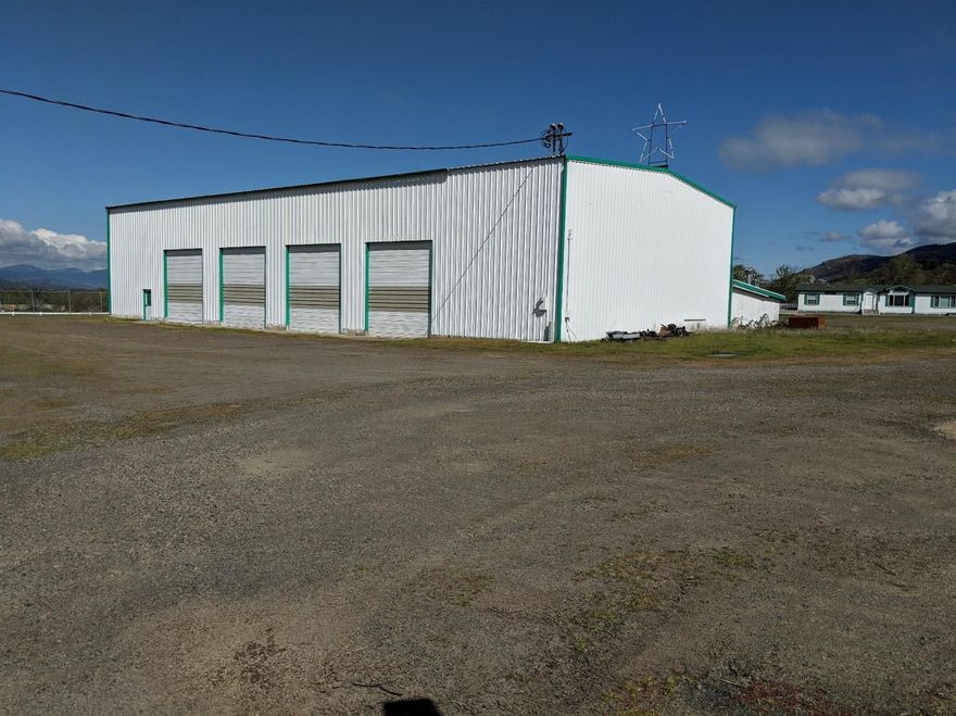 Extremely rare industrial building and acreage in Ashland area! Approximately 7,200sf steel framed shop building on approximately 8.29ac. Zoned Light Industrial with great visibility from I-5 North and South. Property is very well maintained with much of the site fenced and improved with rock base/gravel suitable for heavy equipment and truck use. Features of the main warehouse/shop include heavy power, six 16' x 12' roll-up doors (includes two drive through bays), heavy duty air compressor with lines throughout building and 500amp welder outlets. Property also features newer 1,125sf warehouse/storage building, a newer manufactured home and a older manufactured office building. Existing environmental reports available to buyers. Property is being sold as is, where is. EXCLUSIONS TO LISTING - Ask listing Broker for details.