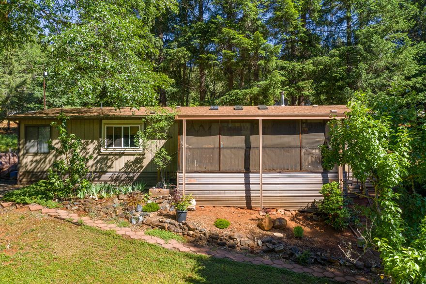 Looking for your own private oasis?  This property is both private and beautiful with a creek running through it!   Sit out on your sweet covered porch and have your morning coffee, BBQ outside, garden anyone?  This well kept manufactured home boasts 2 bedrooms and 2 bathrooms, certified wood stove, double paned windows and there is a detached finished shop.  All this for a great price - don't miss out!