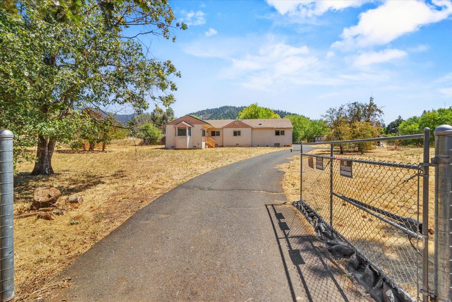 Come and tour this home located on a private 2 acre lot within 2 minutes to town! This property features an inground swimming pool, a barn, greenhouse, a home with lots of potential, a paved driveway, fully fenced for your security, and don't forget about the solar! Fully owned solar system, which keeps the power bill extremely minimal. This 3 bedroom 2 bath home features just under 1600 sqft, a woodburning stove, a single car detached garage, a courtyard to hang out in and an opportunity to come in and make it your own with a few finishing touches! Don't wait to view this special property, it won't last long.