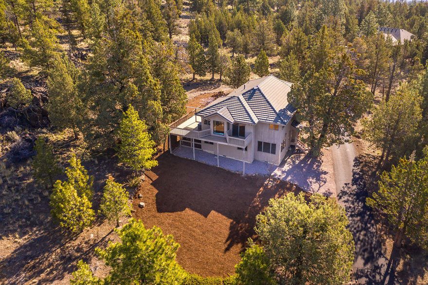 Incredible and hard to find property atop Awbrey Butte on over 2 acres with stunning Cascade Mountain views! Private and immaculate with vaulted ceilings, three car garage and unsurpassed privacy close in on the west side of Bend! Watch nature go right by your door! Beautiful paver walkway to large front entry. The main floor features enormous primary suite, office/bedroom, living room with tongue and groove ceilings, fireplace and built ins + Kitchen and dining with views from every window! Kitchen area features a huge pantry with sliding doors out to deck for flawless entertaining, birdwatching, or simply enjoying the serenity while looking out to the 3 Sisters! Wonderful separation of spaces can be found as you head downstairs to find two guest bedrooms, bathroom, laundry, 2 flex spaces, and gas stove w/thermostat. There is room for everyone here! Central Vac, loads of storage inside and out; including a wine storage area downstairs! Please see 3D virtual & Video Tour + floorplan!