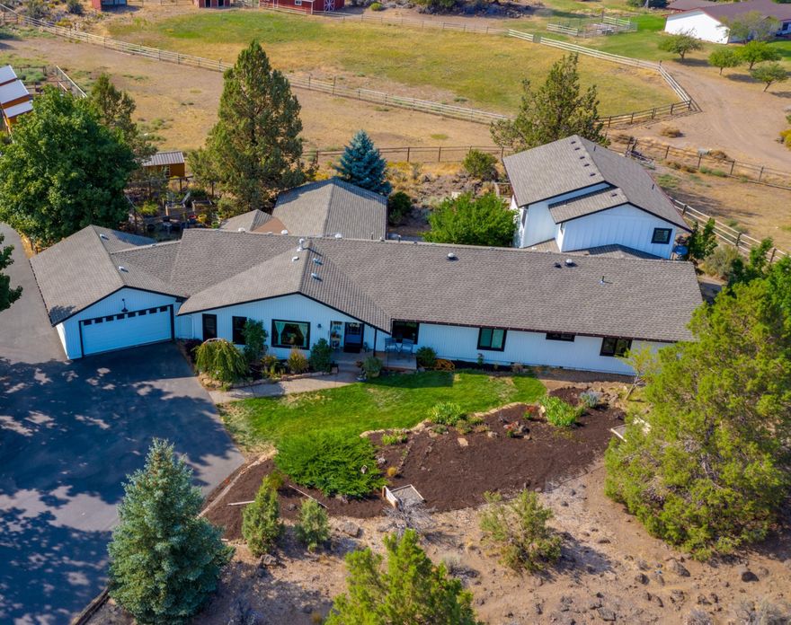 Fantastic horse property only minutes from beautiful downtown Bend. This stunning 3636sqft home was fully remodeled in 2016. The  kitchen, which features custom cabinets, SS appliances & granite countertops, opens to the main living room, which has a fireplace adorned with reclaimed wood hearth & mantle creating a welcoming environment. The home boasts 5 bedrooms plus and office. The primary suite has a spa like bathroom and heated tile floors. The hot tub is just off the primary with mountain views. 2 of the other 4 bedrooms are ensuite. All the bedrooms and 4.5 baths are on the main floor, as are the laundry room and office. Enjoy the outdoors all year long under the spacious covered deck, or relax on the paver patio courtyard. The large bonus room delivers breathtaking views of the Cascade Mountain Range. The property has 5 fully fenced and cross fenced acres with 2.3 acres irrigation. This property is ready for all your animal and toy storage needs! Schedule your showing today.