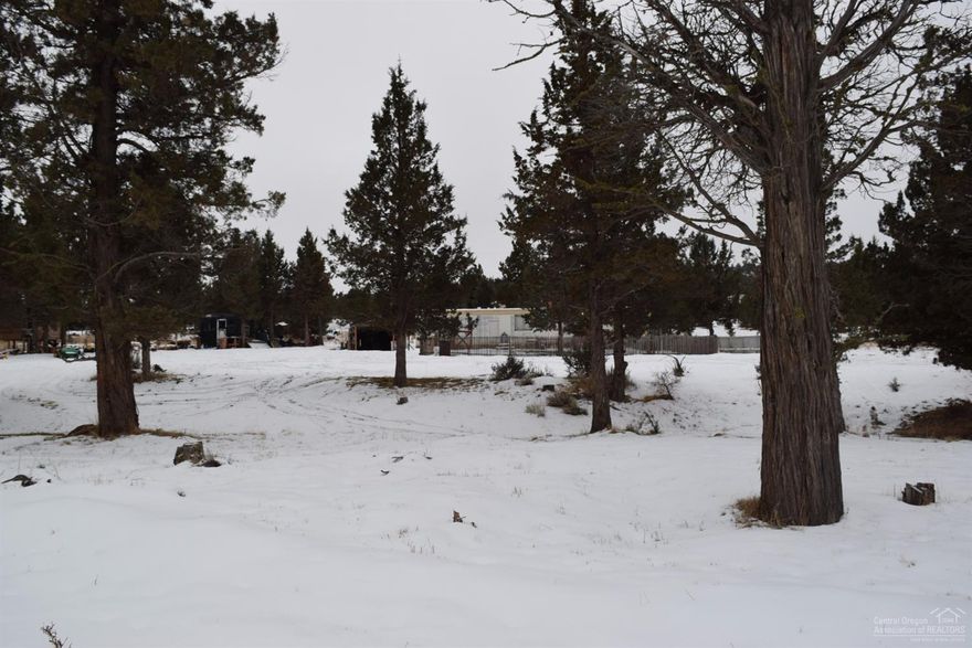 Nice starter place with a couple of acres for outdoor fun. Enjoy foothills view from the single wide with 2 bedrooms, 1 bath, and upgraded kitchen cabinets. Nice woodstove to keep warm with in the colder Winter months. Includes a storage building and a portable cover for a vehicle. Fenced front yard. Best part is the Owner Carry Contract option. Preferably $20K down, payments over 10 years at 5 percent interest.