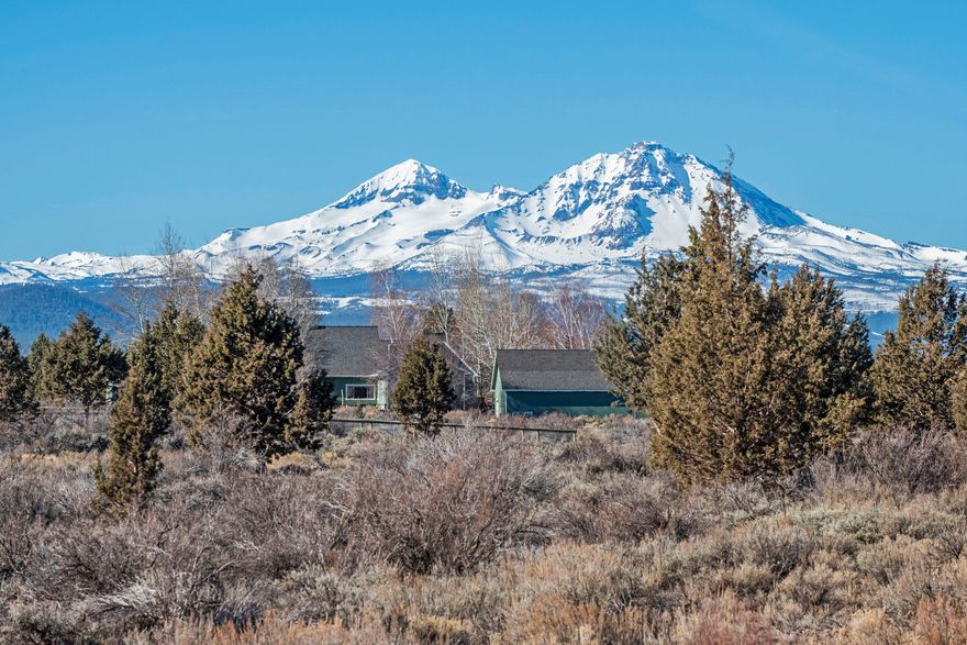 Unbelievable mountain views from this beautiful, 3 bedroom/2.5 bath home on 9.23 acres of undeveloped, horse property. You'll feel right at home with the hardwood floors, artisan tile detail, Venetian plaster finishes, arched doorways and craftsman wood details. A propane stove surrounded by stone hearth/chimney warms the great room. Covered front porch, rear deck, water feature and storage building with concrete floor round out the outdoor features.
 Beautifully maintained, low maintenance landscaped property with perennial flower beds, paved driveway, 3 car garage (with bonus space above) and additional storage bay.