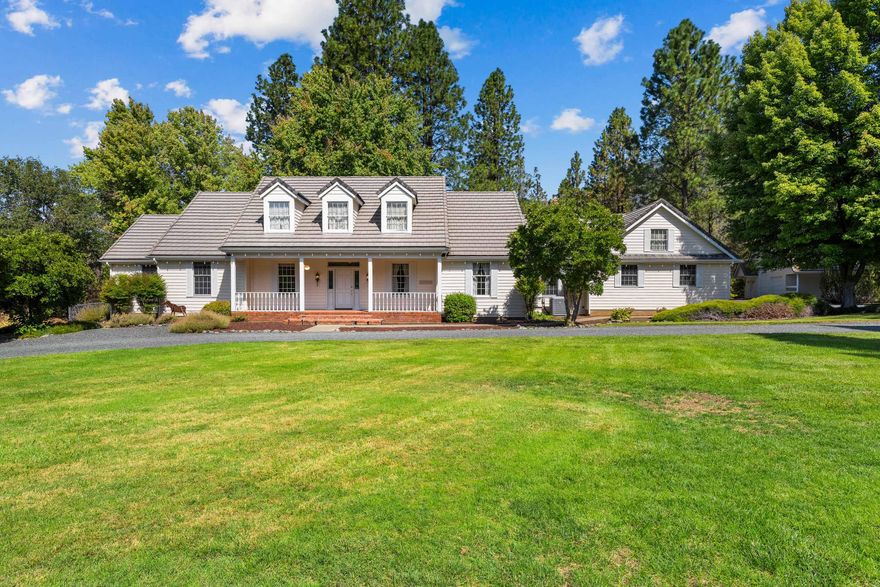 Your Southern Oregon retreat awaits! Located in the highly desirable Colonial Valley, this stunning 4 bedroom, 2.5 bath home offers 2,620 sq ft of thoughtfully designed living space on 5.28 flat, usable acres at the end of a quiet cul de sac. The property features a serene pond and the gentle flow of Louse Creek, creating a peaceful and private setting to enjoy the natural beauty of the grounds. Inside, enjoy a chef's kitchen with Wolf range, spacious living room, hardwood floors, cozy fireplaces, oversized laundry room, and a newer heat pump. Outside, a tile roof, newer trex deck, and brand new well pump complement the large detached garage/barn with oversized doors and a separate room plumbed for water, ideal for guests, creative space, or potential multifamily use. Opportunities like this are rare! Experience the lifestyle, privacy, and beauty of Serenity Ln.