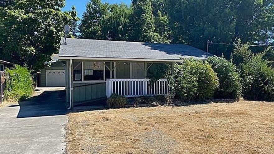 Charming home on spacious lot in the sweet city of Rogue River. Close to 1200 sq ft, this nicely updated home is clean as a pin and move-in ready with new flooring, double-pane vinyl windows and heat pump.  Huge living room offers abundant natural light, while the large kitchen features granite counters, floor to ceiling pantry with custom pull-out drawers, and connects to a separate spacious dining room, perfect for holiday gatherings.  
The bathroom boasts a large walk-in shower.  Large laundry/utility room. Detached oversized 2 -car garage with convenient workbench too. 
Set on a .26 acre fenced lot, you'll enjoy plenty of outdoor space, including a deck ideal for morning coffee or weekend barbecues. 
Don't miss this rare opportunity to own a well-kept home with both comfort and charm just blocks from schools, restaurants and shopping.