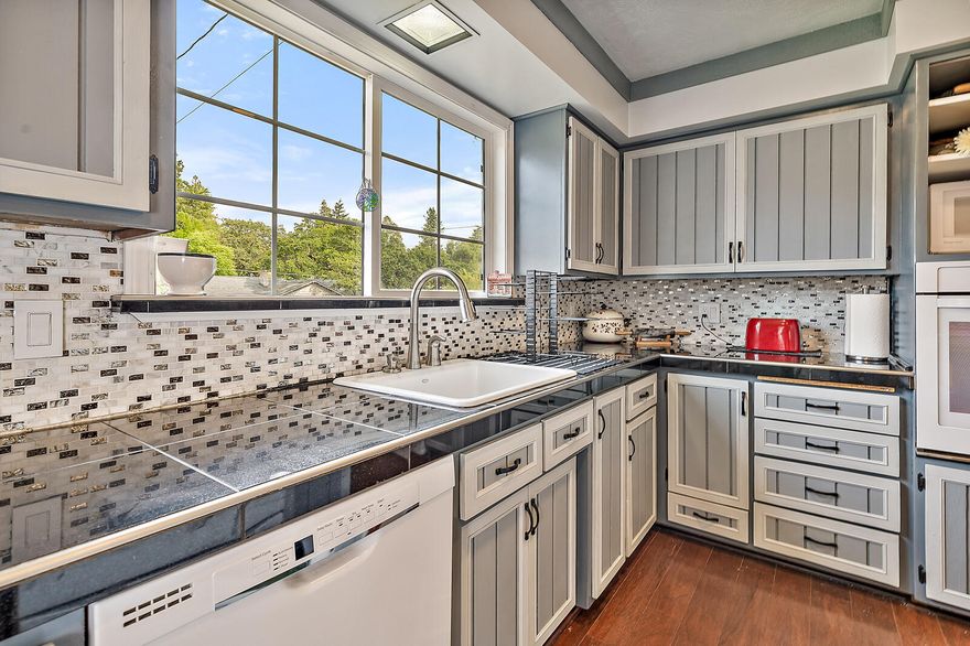 Lovingly updated 4+ bedroom, tri-level home on large East Medford lot. Located minutes from most of town is this well-maintained home. The home has 4 bedrooms plus an office that could serve as a 5th bedroom. Main level of the home boasts engineered hardwood flooring along with a wood fireplace that has an amazing blower system. The recently updated island kitchen is displaying new cabinet fronts, granite counters, tile backsplash & new dishwasher. Updating of the guest bathroom includes tile shower, new vanity and flooring. Enjoy a master bath with dbl. vanity, granite counters, tile shower surround and marble floor with granite trim. The carpet in the bedrooms is also newer. This large lot affords a capacious backyard as well as plenty of room for RV and off-street parking. The owners have left a couple projects for you to complete (they can't have all the fun...). Come take a look!