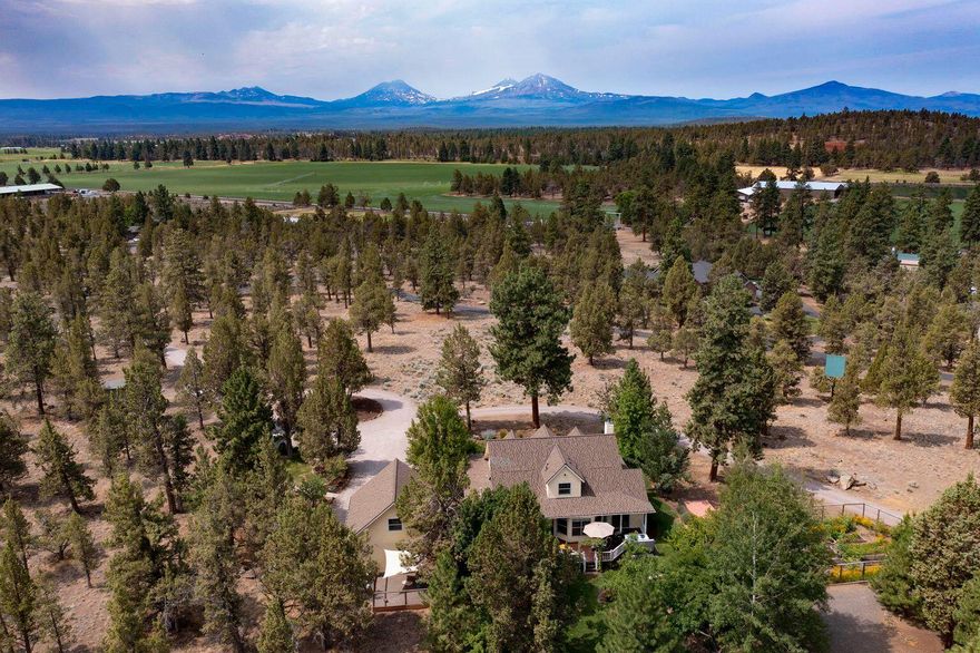 Custom built Farmhouse in charming rural setting. Breathtaking Mountain views from most every room. Wrap around porch & back deck for entertaining. Water feature in back is relaxing & beautiful with mature landscaping. Large fenced in garden with raised beds, fruit trees & berries with irrigation system in place. Horse barn has two stalls, heated tack room, hay storage & paddocks. Home has beautiful oak floors, cabinets, & molding throughout. Spacious primary bedroom on main floor with updated bath. Other rooms are amply sized with additional storage. Fantastic mud/laundry room. Open kitchen & dining. Fireplace Xtrordinair with slate & river rock in living room. The ADU is currently being used as an active and profitable Airbnb. The unit is 377 sq ft, located above garage, with full bath & wonderful mountain views. The home is both nostalgic and charming. You'll feel right at home.