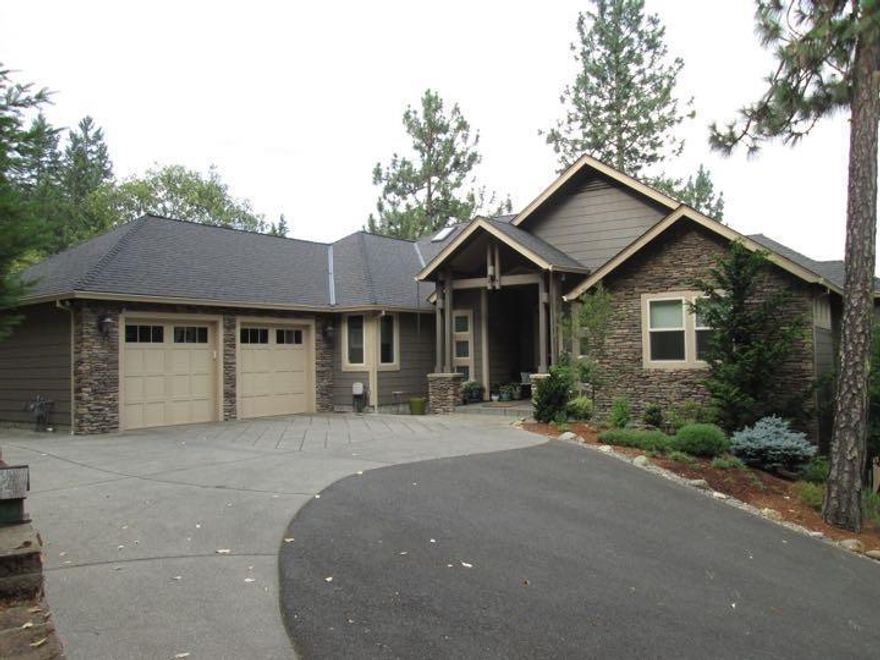 Phenomenal home in town on over an acre with spectacular views. This is not just a home---it's a work of art. Quality flows from every nook and cranny. Just listed almost $150,000 below tax assessed value this home is a true bargain. Vaulted ceilings with massive old barn beams accentuate the great room that looks out over the astounding view of the city below. The kitchen and all the home has scores of custom cherry cabinets and topped with slab granite counters and accented with hand made tiles created by local artisans. There is a downstairs area for entertaining with a separate living quarters and kitchen and it flows out onto the enormous fully fenced back yard with an in ground swim pond and two water falls This is truly amazing home with everything you could want for a great price, Come view to appreciate.