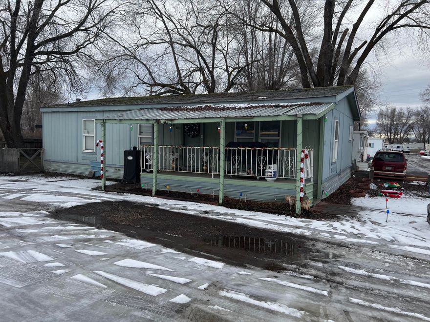 Clean and updated manufactured home in Wiseman's Family Mobile Home Park, ready for it's new owner! Conveniently located as the first home on the left for easy in-and-out access. It features a spacious living room that is open to the dining area and kitchen. The hallway leads to a laundry room, bathroom and three bedrooms, including a primary suite with it's own bathroom. Enjoy a nice sized backyard with a new storage building. Don't miss this move in ready home!