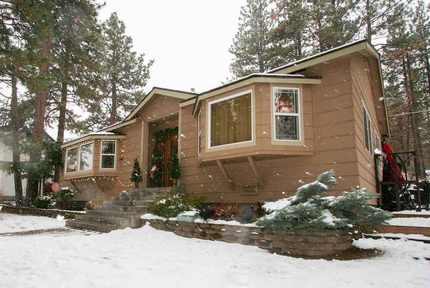 Home nestled on over a half acre and under the big pine trees.  Single level living with this 3 bedroom, 2 bath home.  Detached 2 car garage and a large yard fully landscaped.  Beautiful outdoor living in the summer months.  Come see this stunning home today. Amazing storage area above the garage.  Home on public water but has a septic system.