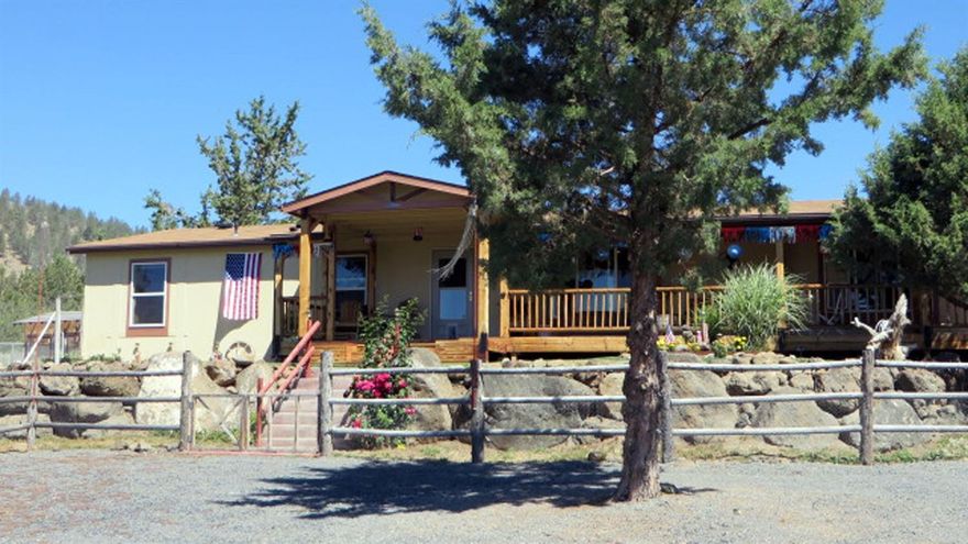 Enjoy the filtered views of green fields and surrounding mountains as you relax on the covered deck in this private setting. Hard to find...20 acres just east of Merrill with 2008 manufactured home in excellent condition with loads of upgrades. Perimeter block foundation. Detached 30'x30' garage/shop with blt-in work benches, great lighting and 9' (h) door. Newer 22'x48' pole barn with metal roof and sides, and 4 framed doors. Property is nearly all perimeter fenced. There are raised garden beds, a greenhouse, a chicken shed and an RV parking pad with power. Super well water with great capacity and a 5 hp submersible pump.