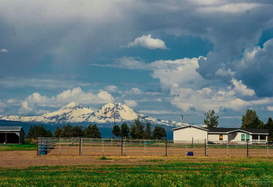 18.65 spectacular acres with irrigation that has it all! Amazing mountain views will take your breath away. There is a 2,400 sq. ft. main residence in addition to the darling original farm house. A fantastic indoor arena with 17 stalls, 2 tack rooms, viewing area, office and caretakers quarters. An outdoor arena, additional horse bar, a large shop with hoist, hay storage runs, and so much more - too much to list! This is a must see, once in a lifetime property.